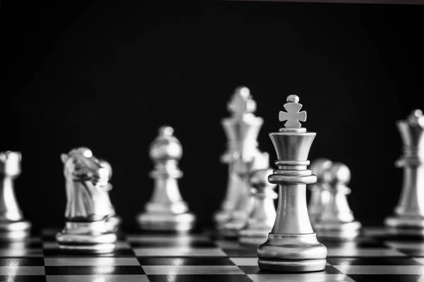 The King in battle chess game stand on chessboard with black iso — Stock Photo, Image