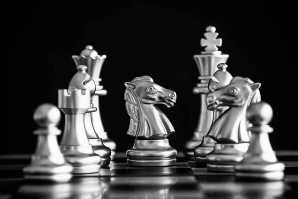 The King in battle chess game stand on chessboard with black iso
