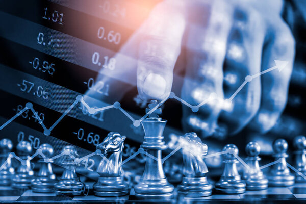 Chess game on chess board on stock market or forex trading graph
