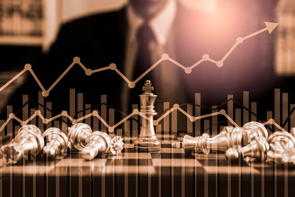 Chess game on chess board on stock market or forex trading graph