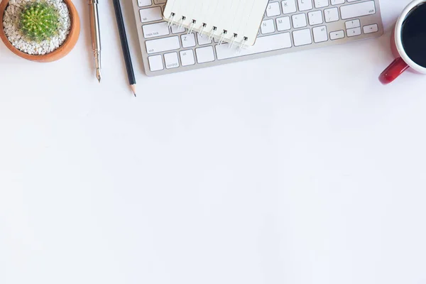 White desk office with laptop, smartphone and other work supplie