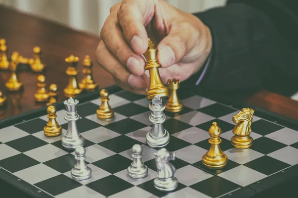 Chess game on chess board behind business man background. Busine — Stock Photo, Image