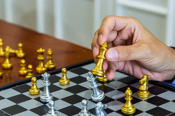 Chess game on chess board behind business man background. Busine — Stock Photo, Image