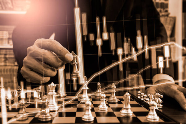 Chess game on chess board on stock market or forex trading graph