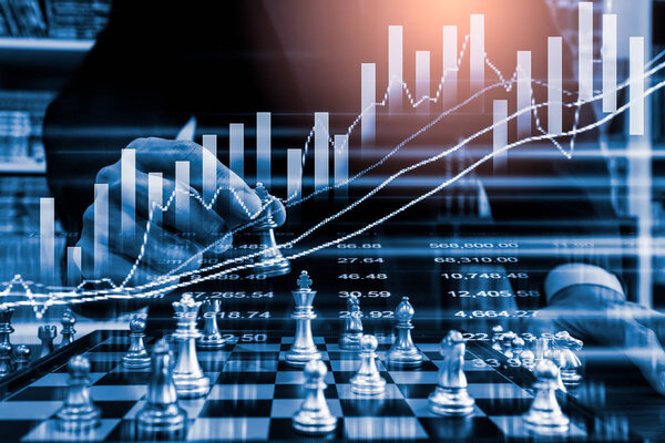 Chess game on chess board on stock market or forex trading graph chart for financial investment concept. Economy trends for digital business marketing strategy analysis. Abstract finance background.