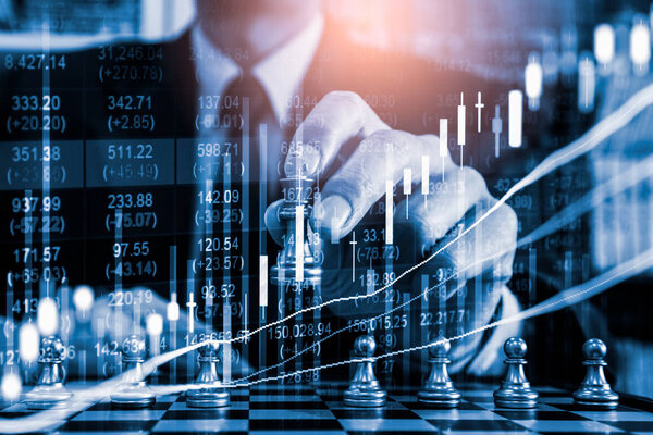 Chess game on chess board on stock market or forex trading graph chart for financial investment concept. Economy trends for digital business marketing strategy analysis. Abstract finance background.