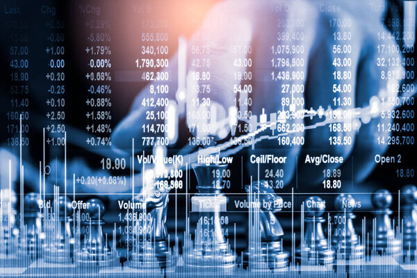Chess game on chess board on stock market or forex trading graph chart for financial investment concept. Economy trends for digital business marketing strategy analysis. Abstract finance background.