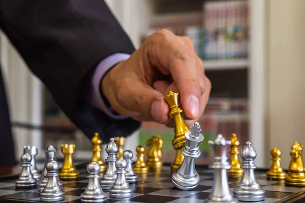 Premium Photo  The golden horse, knight chess piece standing in front of  silver pawn chess pieces on chessboard on dark background. leadership,  follower, team, commander, competition, and business strategy concept.