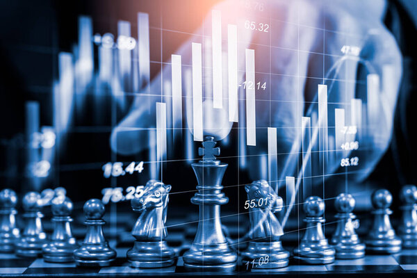 Chess game on chess board on stock market or forex trading graph chart for financial investment concept. Economy trends for digital business marketing strategy analysis. Abstract finance background.