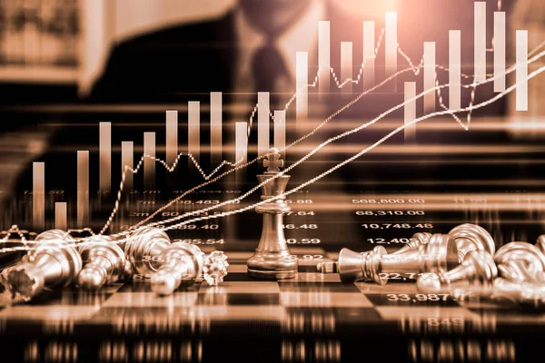 Chess game on chess board on stock market or forex trading graph chart for financial investment concept. Economy trends for digital business marketing strategy analysis. Abstract finance background.