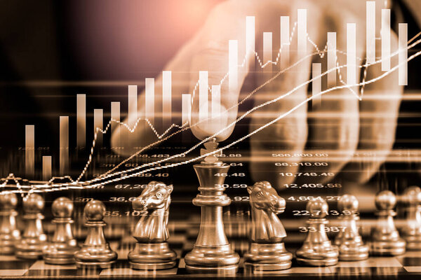 Chess game on chess board on stock market or forex trading graph chart for financial investment concept. Economy trends for digital business marketing strategy analysis. Abstract finance background.