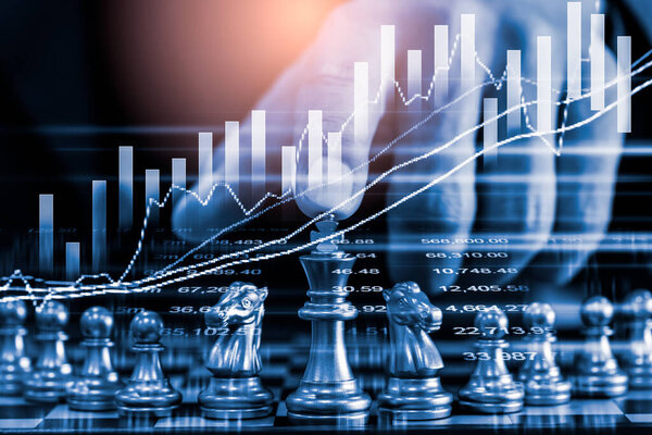 Chess game on chess board on stock market or forex trading graph chart for financial investment concept. Economy trends for digital business marketing strategy analysis. Abstract finance background.