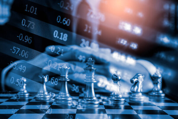 Chess game on chess board on stock market or forex trading graph chart for financial investment concept. Economy trends for digital business marketing strategy analysis. Abstract finance background.