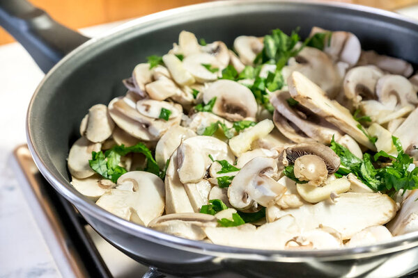 Mushroom slice pan cooking raw closeup