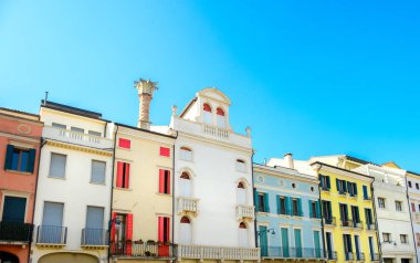 row of Italian residential buildings colorful blue sky clipart