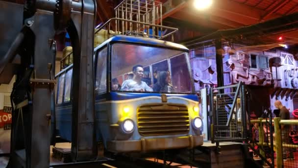 Indoor carnival theme park - An asiatic family on crazy flying bus ride at Luna Farm in Fico Eataly World shop in Bologna - Italy — 图库视频影像