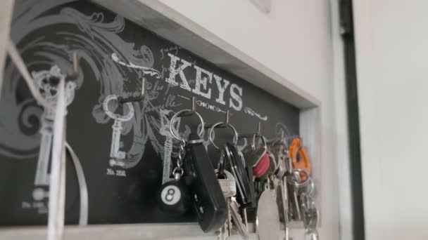 Key hanger background of many keychains in home — Stock Video