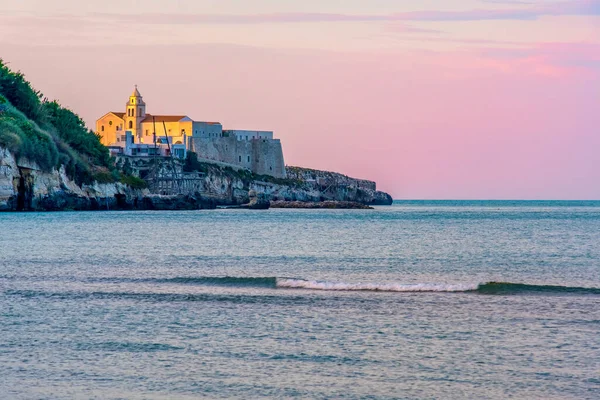 Jižní Itálie pozadí Vieste kostel vesnice při západu slunce u moře s fialovou oblohou — Stock fotografie