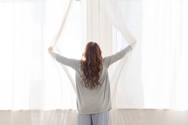 Erkek sabah perdeleri açar