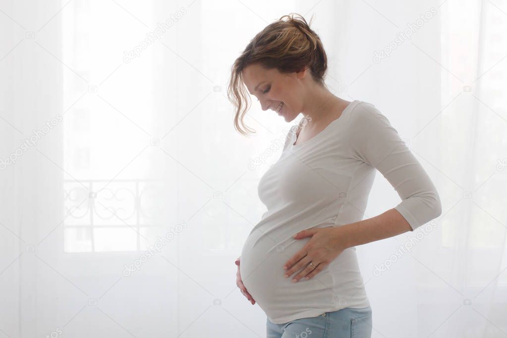 Pregnant woman touching belly