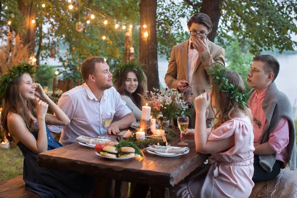 People having dinner in garden