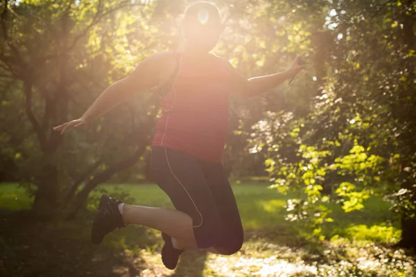 Overweight woman is happy and jumping sport — Stock Photo, Image