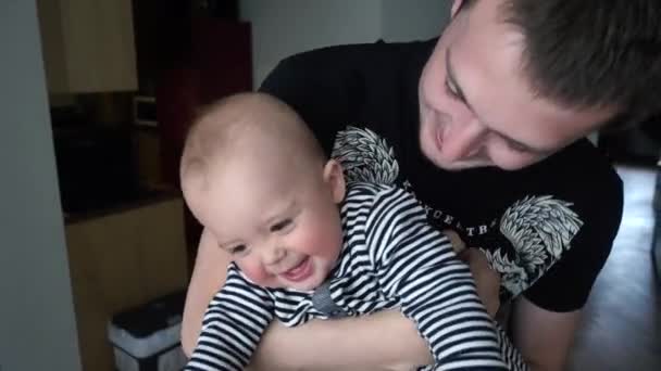 The father and his nine-month-old son are laughing — Stock Video
