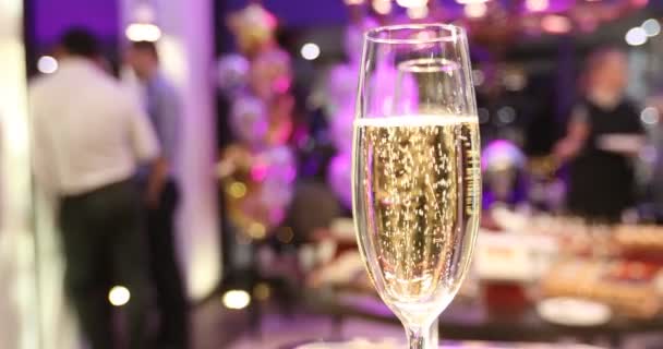 Glass of wine rising bubbles holiday party — Stock Video