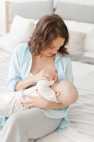 Cheerful woman with baby breast feeding — Stock Photo, Image