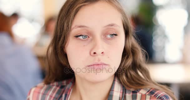 Sad, depressed young woman sitting in cafe — Stock Video