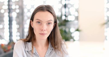 Kamuya açık bir yerde ciddi kadın kameraya görünüyor