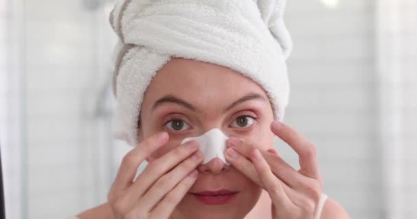 Girl Applying White Nose Patch On Facial Skin — Stock Video