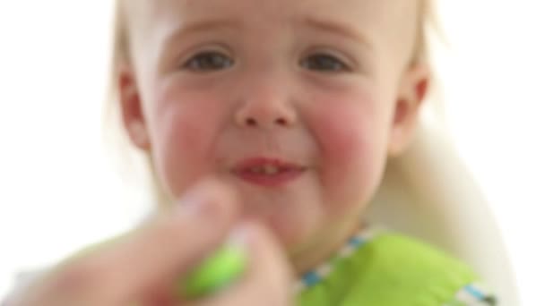 Mother feeding baby with spoon indoors — Stock Video