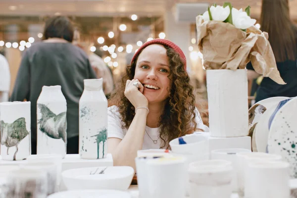 Charming woman among clay artisan utensil — Stock Photo, Image