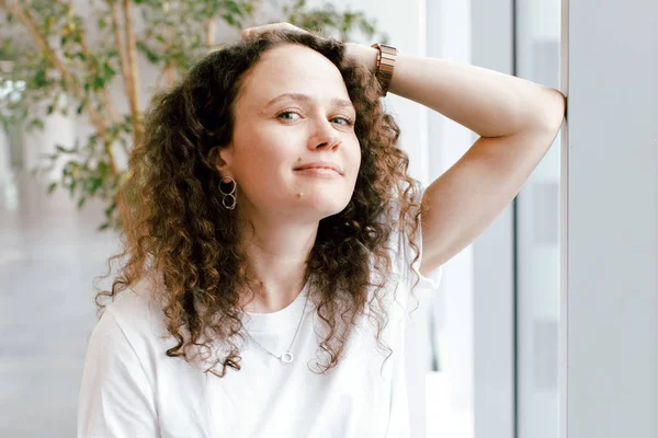 Pretty curly girl in white — Stock Photo, Image