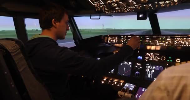 Rear view of pilot operating jet controls — Stock Video