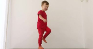 Little funny boy baby is stomps and walks around circles