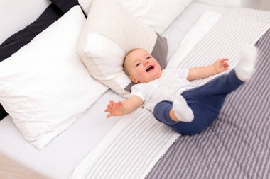 Content toddler smiling on bed