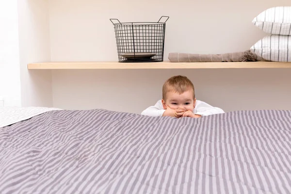 Playful male child in modern bedroom — ストック写真