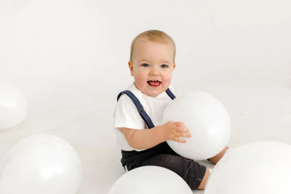 Joyful little kid with balloons in studio — Stockfoto
