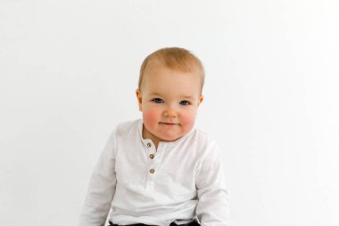 Joyful little kid with balloons in studio