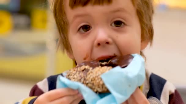 Little boy enjoying chocolate dessert — Stockvideo