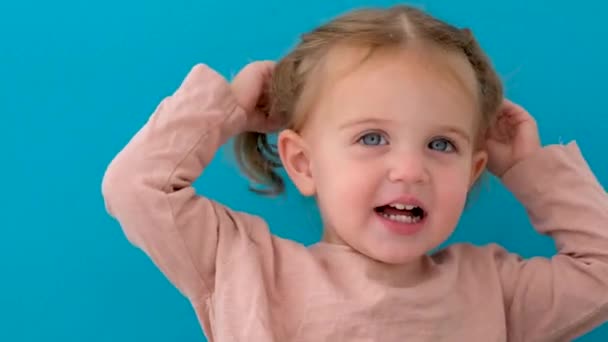 Beautiful little girl in studio ponytails — Stock Video