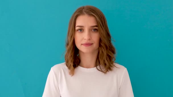 Woman in white t shirt looking at camera — Stock Video