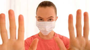 Woman putting on surgical mask for corona virus prevention clipart