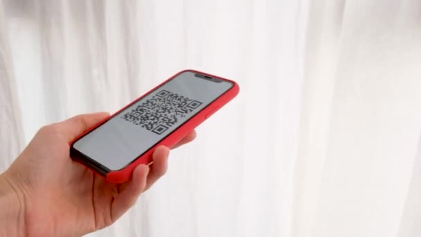Hand holding mobile smart phone with QR code — Stock Video