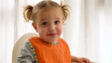 Komik kız yemek sırasında kameraya bakıyor.