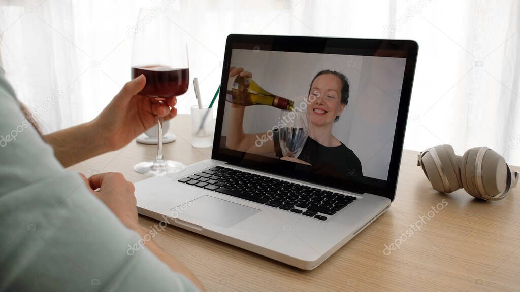 Women talking on a webcam with wine