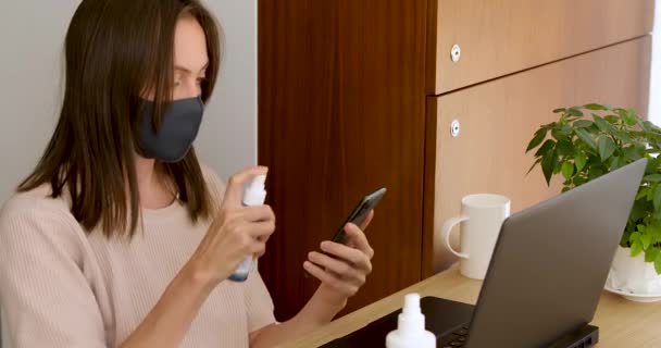 Woman in mask disinfection smartphone — Stock Video