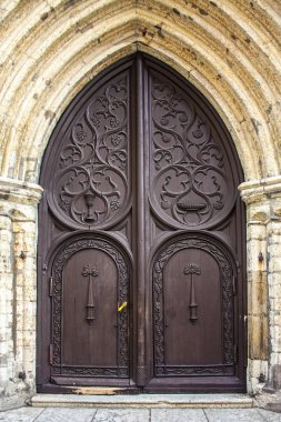 Old wooden door of Church of St Olaf in Tallinn, Estonia clipart